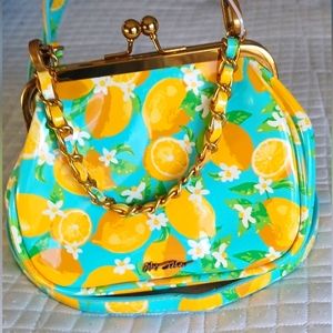 Betsy Johnson mini bag with lemon/flower design and chain handle.